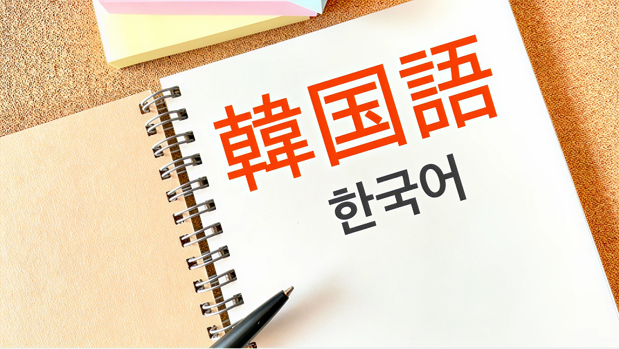 ノートとペン。ノートには韓国語という文字がかかれている。